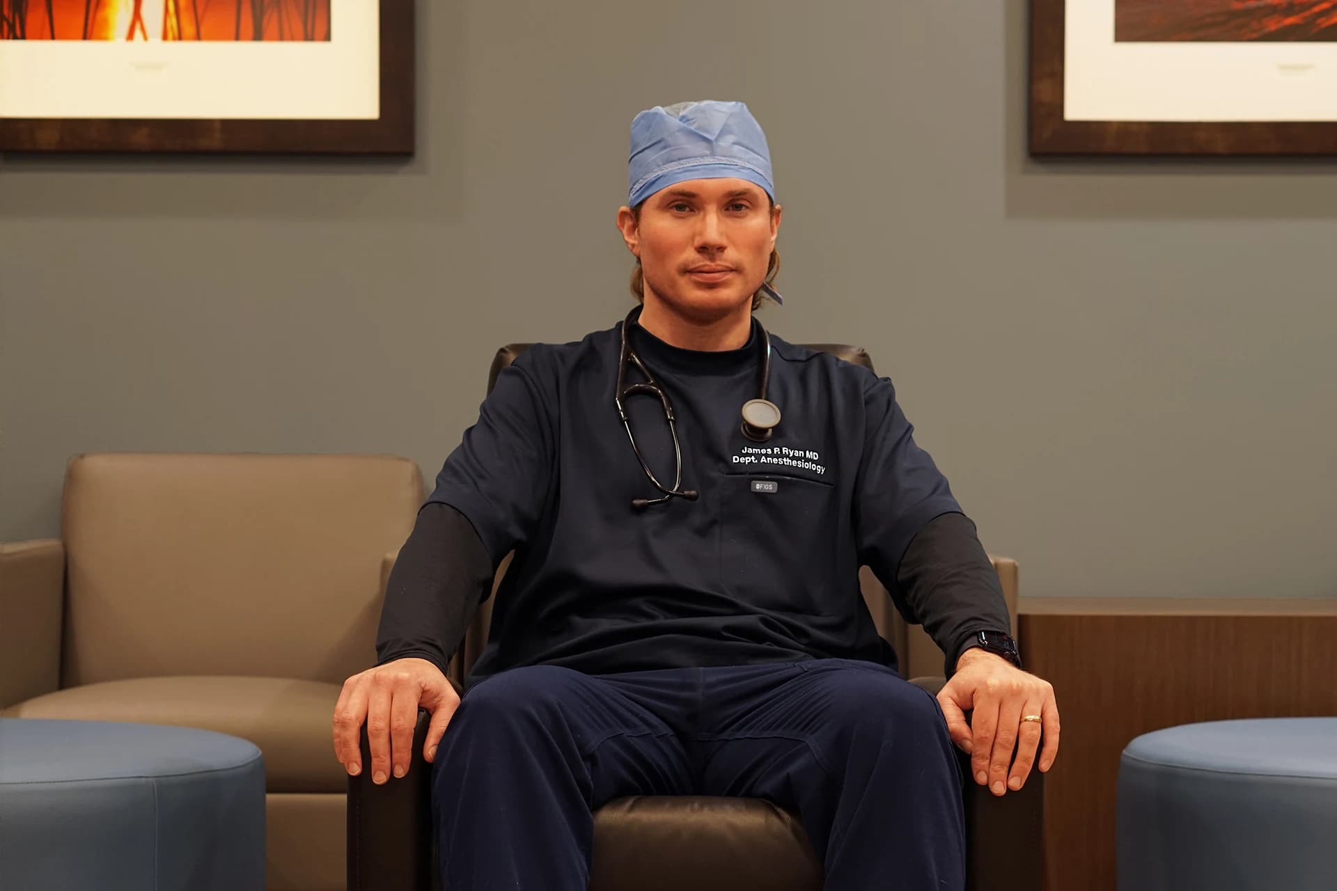 Quality committee reviewing de-identified case summary on laptop in meeting.